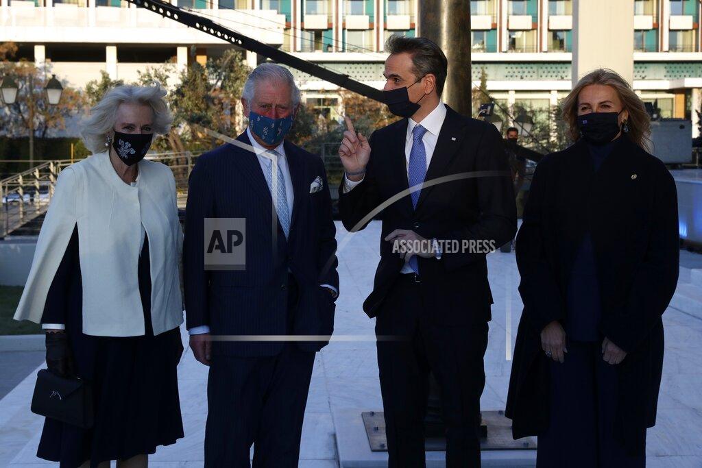 Yorgos Karahalis Greece's Prime Minister Kyriakos Mitsotakis, second right, and his wife Mareva Grabowski, right, welcome Britain's Prince Charles, second left, and his wife Camilla, the Duchess of Cornwall, left, at Greece's newly renovated National Gallery in Athens, Wednesday, March 24, 2021. Greece on Wednesday kicked off two days of celebrations to mark the bicentenary of the start of the country's war of independence, although events are far more muted than originally planned due to the pandemic. (AP Photo/Yorgos Karahalis)