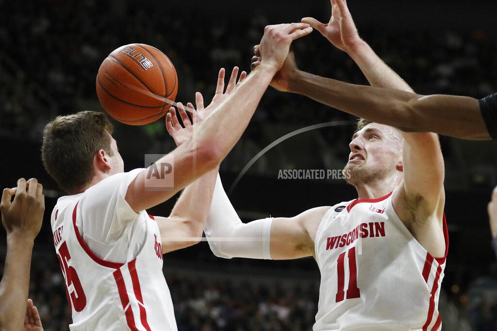 Carlos Osorio Wisconsin forwards Nate Reuvers (35) and Micah Potter (11) reach for a rebound during the first half of an NCAA college basketball game against Michigan State, Friday, Jan. 17, 2020, in East Lansing, Mich. (AP Photo/Carlos Osorio)