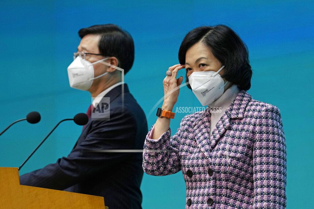 Kin Cheung Hong Kong Chief Executive John Lee, left, and convener of the Executive Council Regina Ip attend a news conference in Hong Kong, Tuesday, July 5, 2022. Lee said Tuesday in his first news conference since taking the reins that he will work towards legislating easing restrictions for travelers, but that it must be balanced with limiting the spread of the coronavirus so as not to overwhelm the healthcare system. (AP Photo/Kin Cheung)