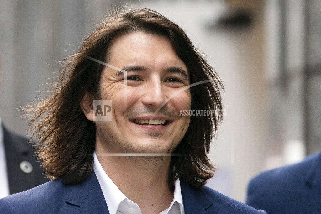 Mark Lennihan Vladimir Tenev, CEO and Co-Founder of Robinhood, walks in New York's Times Square following his company's IPO, Thursday, July 29, 2021. Robinhood is selling its own stock on Wall Street, the very place the online brokerage has rattled with its stated goal of democratizing finance. Through its app, Robinhood has introduced millions to investing and reshaped the brokerage industry, all while racking up a long list of controversies in less than eight years. (AP Photo/Mark Lennihan)