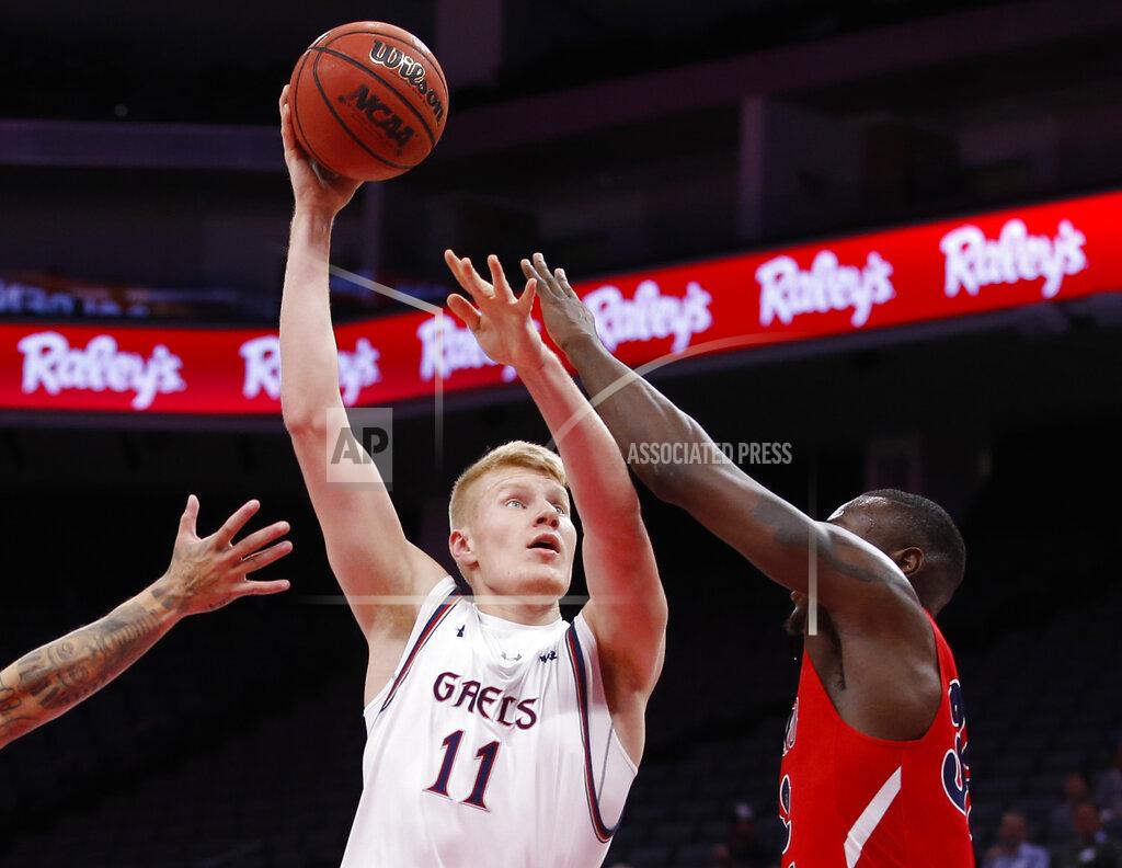 Rich Pedroncelli Saint Mary's forward Matthias Tass, left, shoots over Fresno State's forward Nate Grimes during the first half of an NCAA college basketball game in Sacramento, Calif., Wednesday, Nov. 20, 2019. (AP Photo/Rich Pedroncelli)