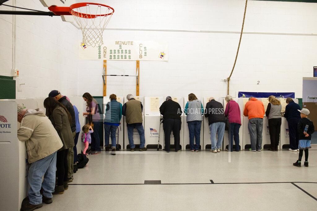 FILE - In this Nov. 6, 2018, file photo, voters cast their ballots at Collister Elementary in Boise, Idaho. On Tuesday, May 19, 2020, Idaho is holding an entirely mail-in primary for the first time as the state works to slow the spread of the coronavirus pandemic. (AP Photo/Otto Kitsinger, File)
