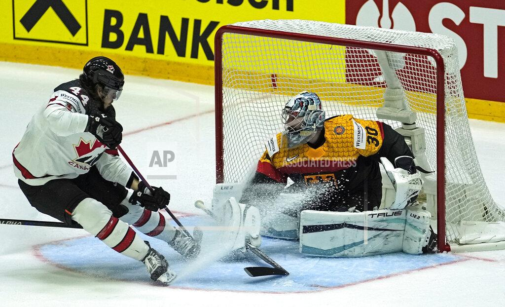 Martin Meissner Keeper Philipp Grubauer of Germany is challenged by Canada's Maxime Comtois, left, during the group A Hockey World Championship match between Germany and Canada in Helsinki, Finland, Friday May 13, 2022. (AP Photo/Martin Meissner)