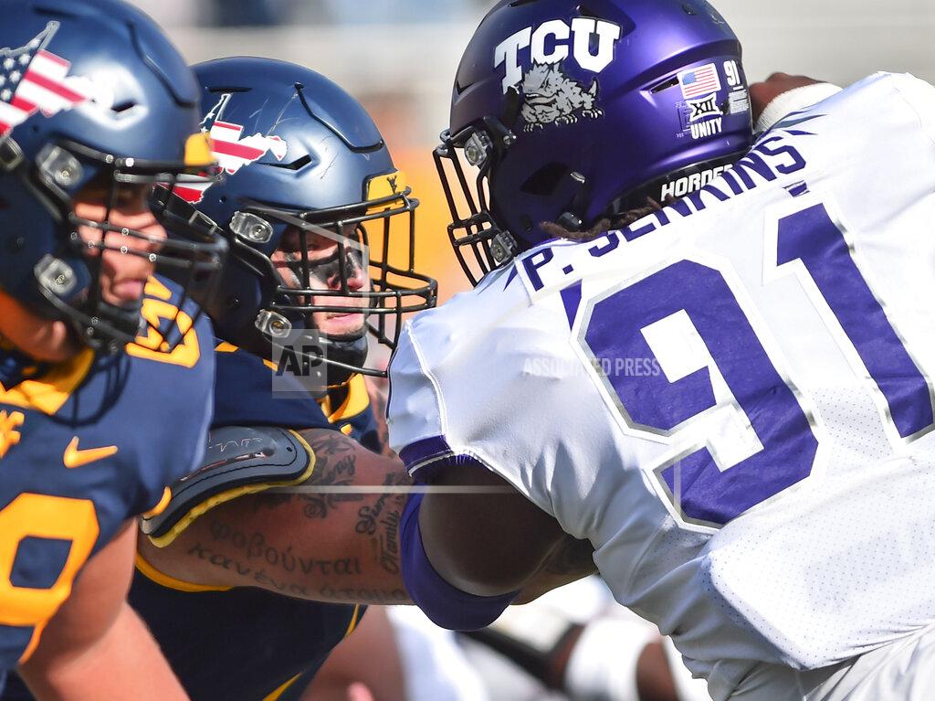 William Wotring West Virginia offensive lineman James Gmiter (74) blocks TCU defensive tackle Patrick Jenkins (91) during the second half of an NCAA college football game on Saturday, Nov. 14, 2020, in Morgantown, W.Va. (William Wotring/The Dominion-Post via AP)
