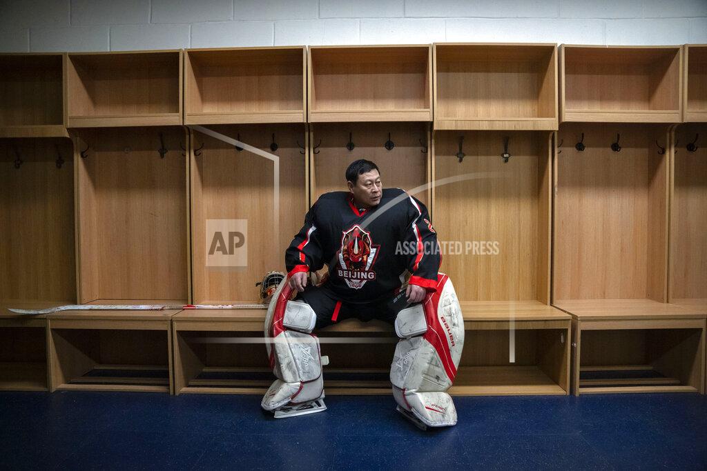 Mark Schiefelbein A member of the "1979" hockey club sits in the locker room before a match at a hockey rink in Beijing, Wednesday, Jan. 12, 2022. Spurred by enthusiasm after China was awarded the 2022 Winter Olympics, the members of a 1970s-era youth hockey team, now around 60 years old, have reunited decades later to once again take to the ice. (AP Photo/Mark Schiefelbein)