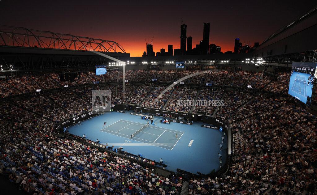 Andy Wong Switzerland's Roger Federer and Serbia's Novak Djokovic play their semifinal match on Rod Laver Arena as the sun sets at the Australian Open tennis championship in Melbourne, Australia, on Jan. 30, 2020. (AP Photo/Andy Wong)