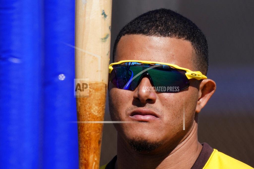 Charlie Riedel San Diego Padres' Manny Machado looks at his bat during spring training baseball practice Tuesday, Feb. 23, 2021, in Peoria, Ariz. (AP Photo/Charlie Riedel)