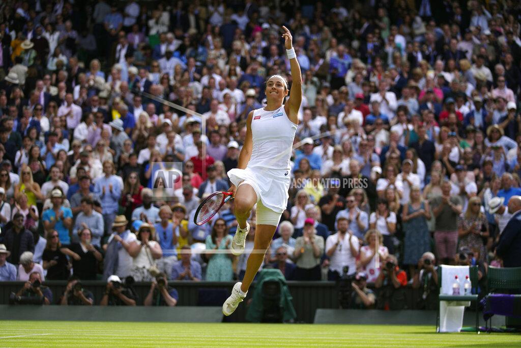 Alastair Grant France's Caroline Garcia celebrates defeating Britain's Emma Raducanu in a singles tennis match on day three of the Wimbledon tennis championships in London, Wednesday, June 29, 2022. (AP Photo/Alastair Grant)