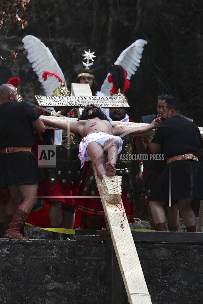 Brando Neri Luna plays the the role of Jesus Christ in the Passion Play of Iztapalapa, outside the Cathedral, on the outskirts of Mexico City, Friday, April 2, 2021, amid the new coronavirus pandemic. To help prevent the spread of the COVID-19, Latin America's most famous re-enactment of the crucifixion of Christ was closed to the public and transmitted live so people could watch at home, for a second consecutive year. (AP Photo/Marco Ugarte)
