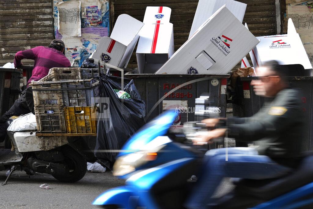 Hassan Ammar A man searches in trash dumpsters for recyclable items to resell next to voting booths that were used Sunday in the Lebanese parliamentary elections, in Beirut, Lebanon, Monday, May 16, 2022. Lebanon's militant Hezbollah group and its allies suffered losses in this weekend's parliamentary elections, with preliminary results Monday showing some of their most vocal opponents picking up more seats and several of their traditional partners routed out of the legislature. (AP Photo/Hassan Ammar)