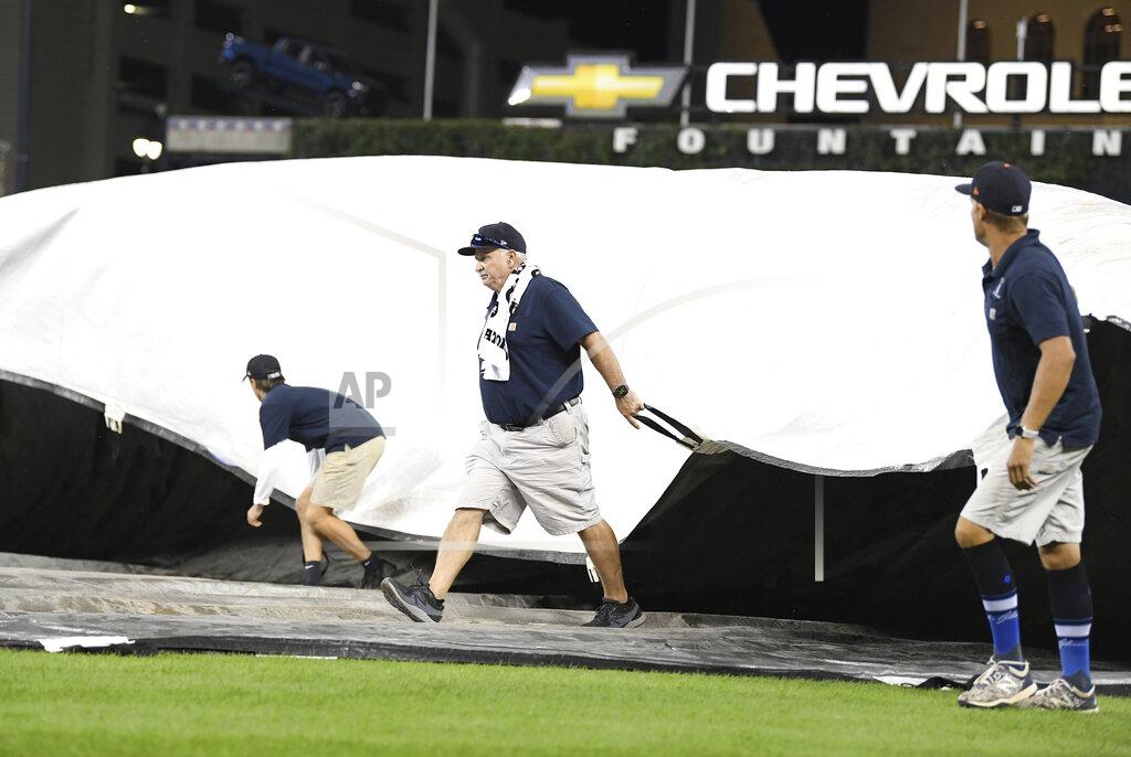 Lon Horwedel Members of the Detroit Tigers grounds crew cover the field with storms approaching after the sixth inning of the team's baseball game against the Milwaukee Brewers in Detroit, Tuesday, Sept. 14, 2021. (AP Photo/Lon Horwedel)
