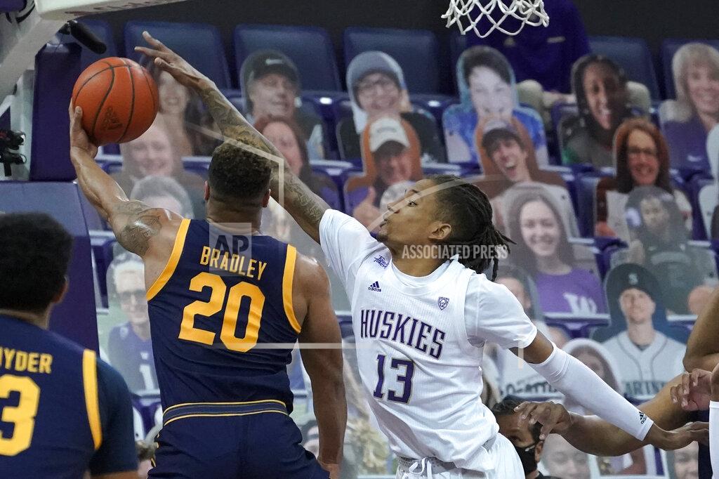 Ted S. Warren Washington forward Hameir Wright (13) blocks a shot by California guard Matt Bradley (20) during the first half of an NCAA college basketball game Saturday, Feb. 20, 2021, in Seattle. (AP Photo/Ted S. Warren)