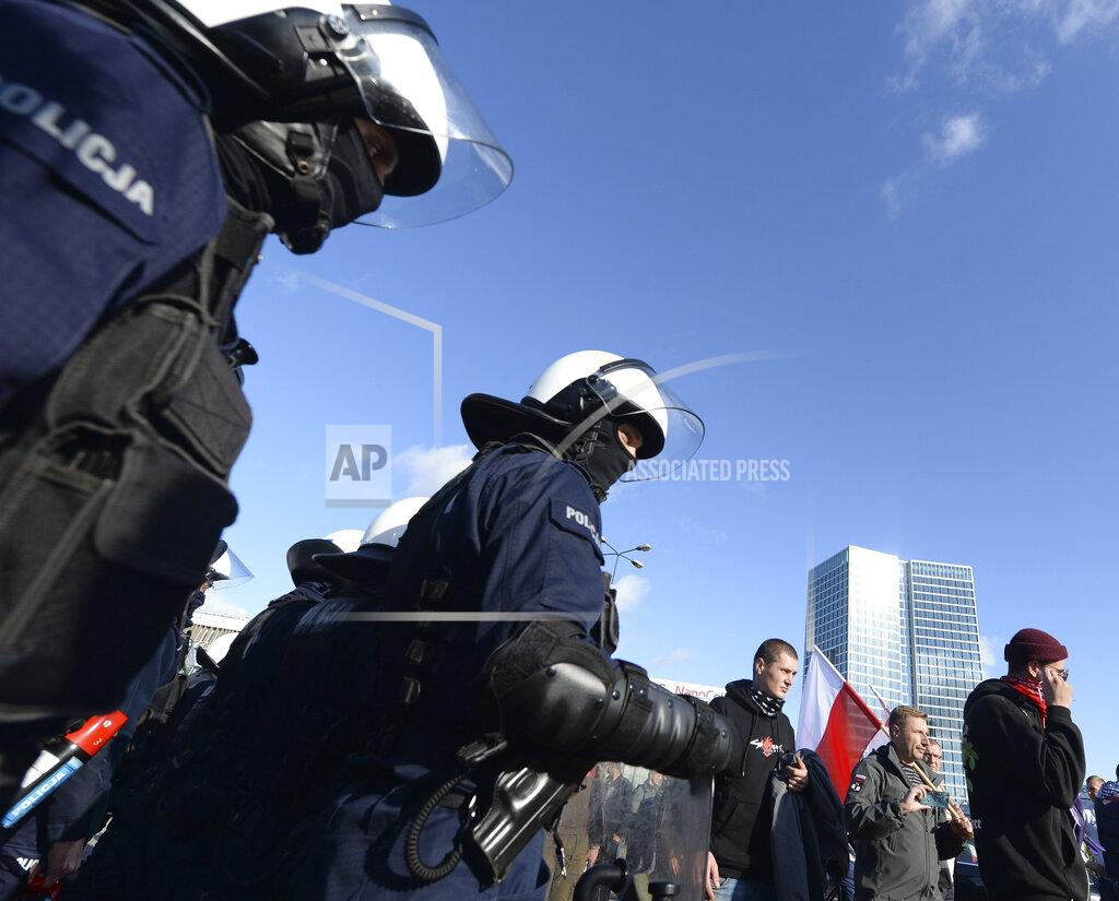 Czarek Sokolowski Polish police face protesters angry over new restrictions aimed at fighting the coronavirus pandemic, in Warsaw, Poland, Saturday, Oct. 24, 2020. The protesters included entrepreneurs, far-right politicians, football fans and vaccine opponents. The protesters, many wearing no protective masks, violated a new restriction on gatherings of more people. The clashes come amid rising social tensions and as new restrictions just short of a full lockdown took effect Saturday.(AP Photo/Czarek Sokolowski)