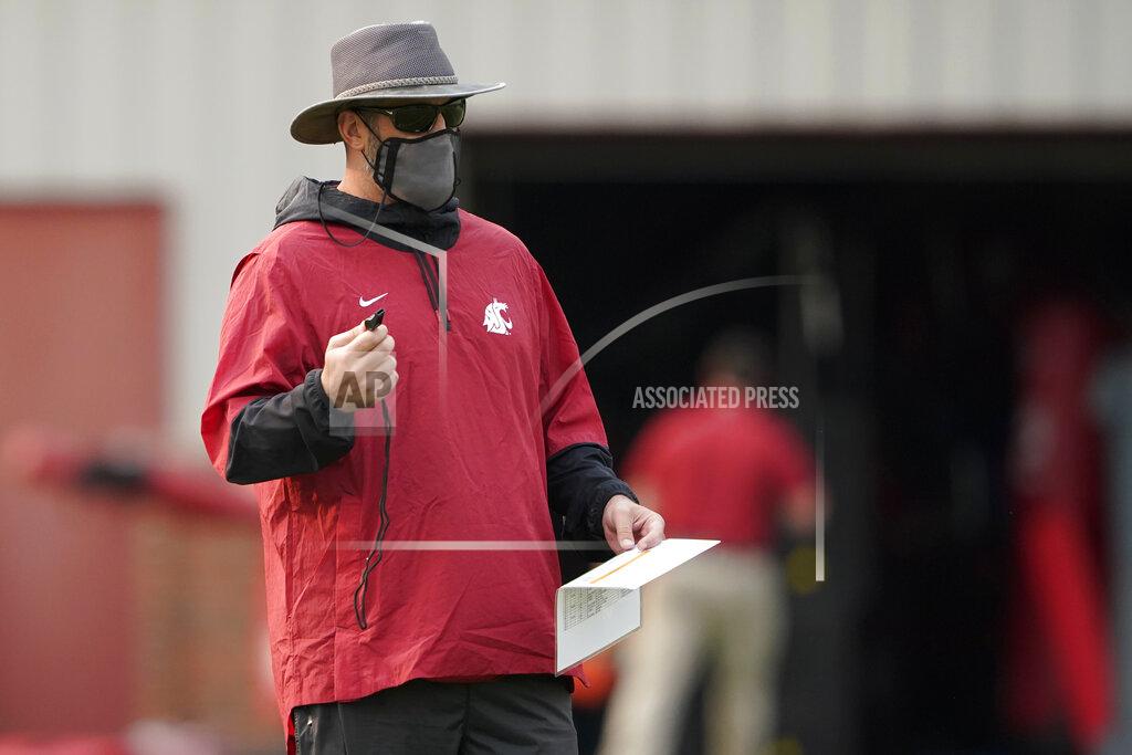 Ted S. Warren Washington State head coach Nick Rolovich watches his players on the first day of NCAA college football practice, Friday, Aug. 6, 2021, in Pullman, Wash. Rolovich would like for attention going into the 2021 season to be focused on players on the field, but he is getting just as much attention around his decision not to receive a COVID-19 vaccination.(AP Photo/Ted S. Warren)