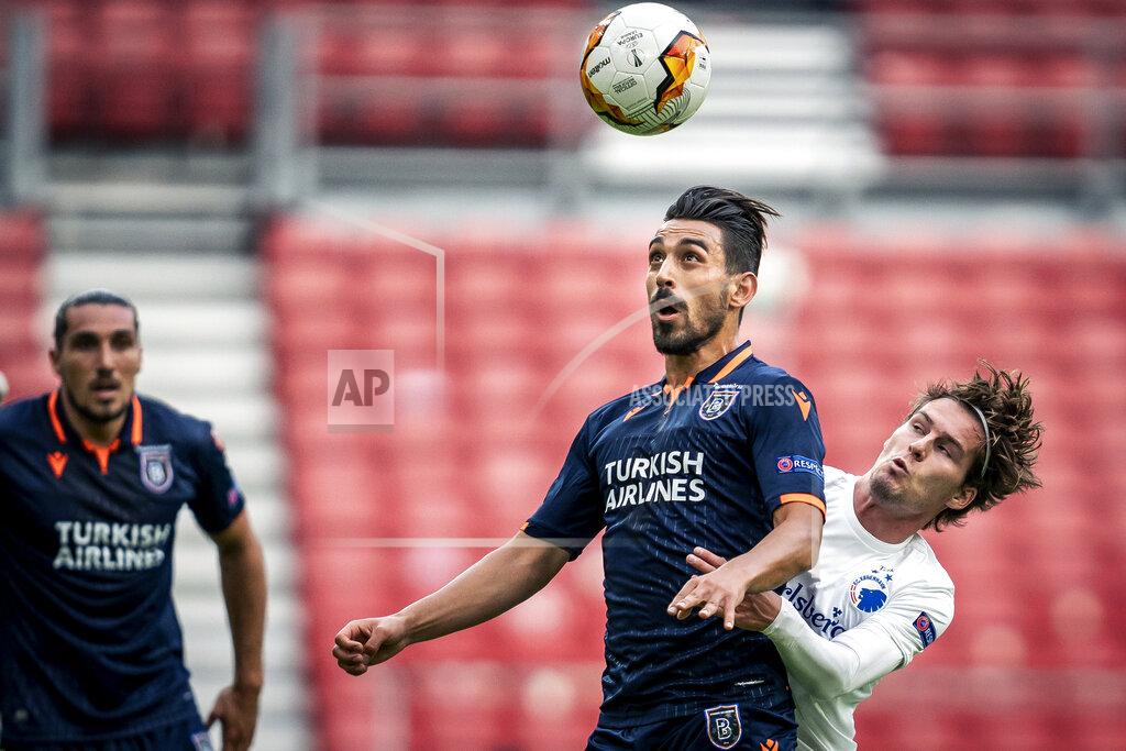 Mads Claus Rasmussen Istanbul Basaksehir's Irfan Can Kahveci, foreground and FC Copenhagen's Robert Mudrazija vie for the ball, during the Europa League round of 16 second leg soccer match between FC Copenhagen and Istanbul Basaksehir, at Telia Parken in Copenhagen, Wednesday, Aug. 5, 2020. (Mads Claus Rasmussen/Ritzau Scanpix via AP)