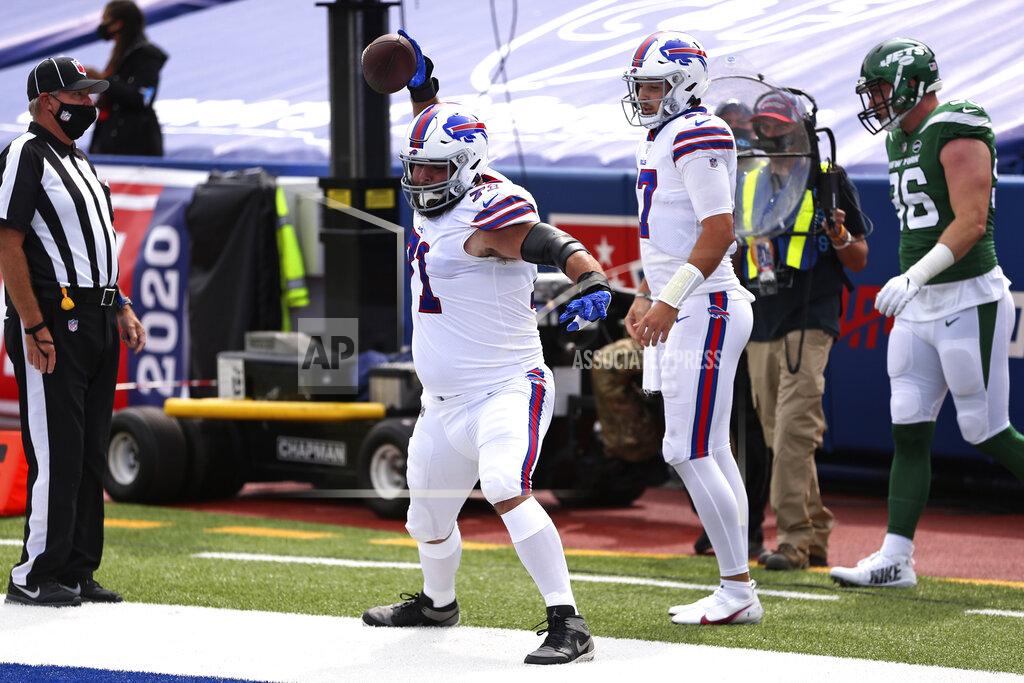 Jeffrey T. Barnes Buffalo Bills offensive tackle Ryan Bates, center, spikes the ball after Josh Allen (17) ran for a touchdown during the first half of an NFL football game against the New York Jets in Orchard Park, N.Y., Sunday, Sept. 13, 2020. (AP Photo/Jeffrey T. Barnes)