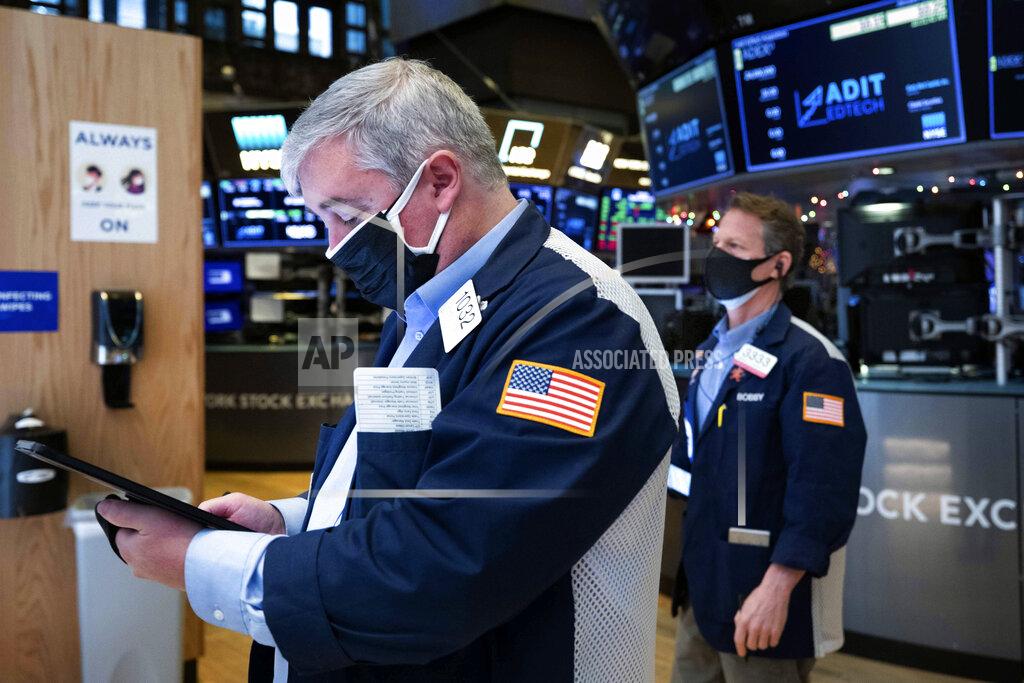 Colin Ziemer In this photo provided by the New York Stock Exchange, traders Edward MacCarthy, left, and Robert Charmak work on the trading floor, Tuesday, Jan. 12, 2021. U.S. stocks are drifting near their record heights Tuesday, while Treasury yields keep marching higher amid expectations that the economy will pull out of its slump after a powerful recovery sweeps the globe later this year. (Colin Ziemer/New York Stock Exchange via AP)