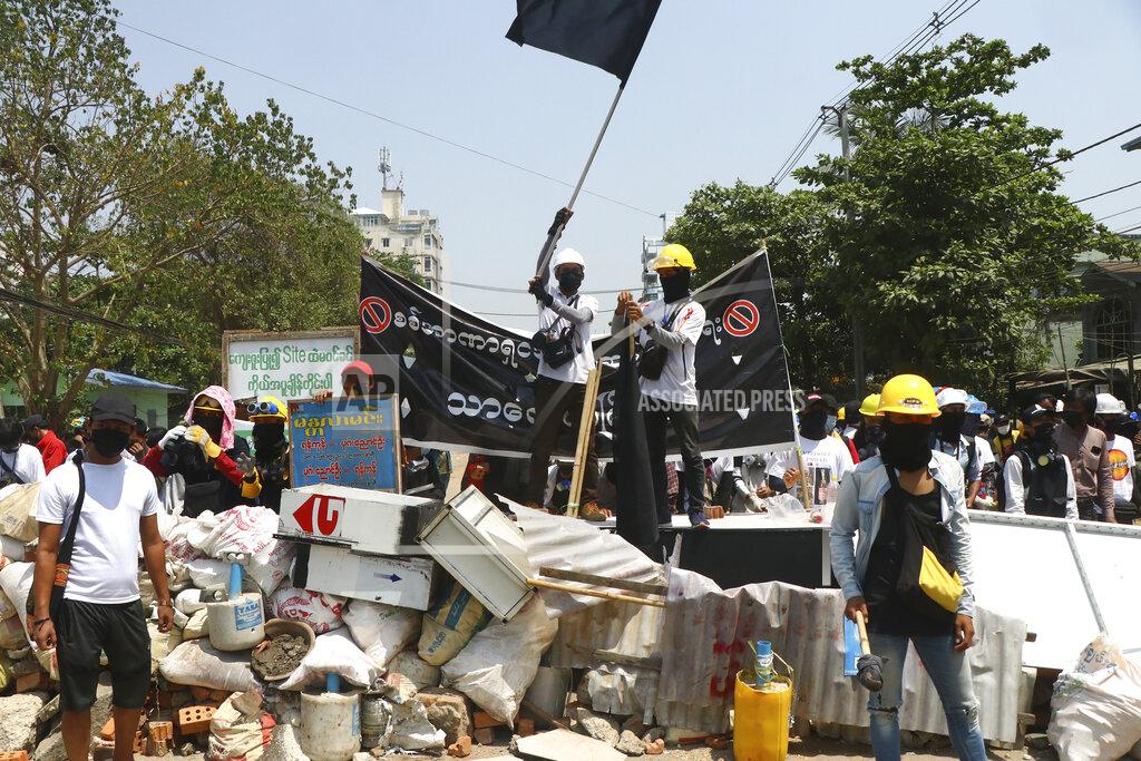 Uncredited Protesters prepare to defend themselves as they gather in Tarkata township, Yangon, Myanmar Saturday, March 20, 20201. Protests against last month's military takeover continued Saturday in cities and town across Myanmar despite a crackdown by security forces that has taken more than 200 lives. (AP Photo)