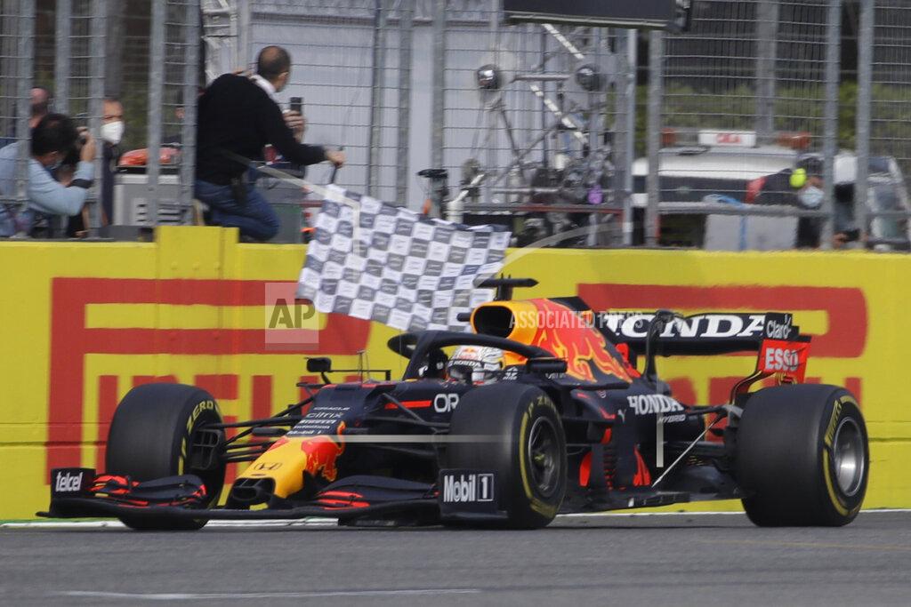 Luca Bruno Red Bull driver Max Verstappen of the Netherlands crosses the finish line to win the Emilia Romagna Formula One Grand Prix, at the Imola racetrack, Italy, Sunday, April 18, 2021. (AP Photo/Luca Bruno)