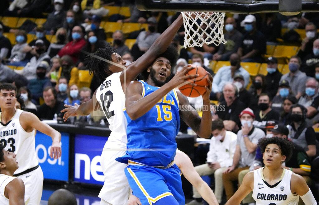 David Zalubowski Colorado forward Jabari Walker, left, fouls UCLA center Myles Johnson during the first half of an NCAA college basketball game Saturday, Jan. 22, 2022, in Boulder, Colo. (AP Photo/David Zalubowski)