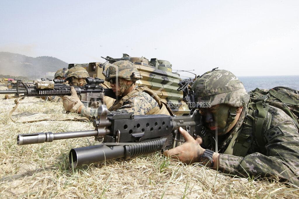 Lee Jin-Man FILE - In this March 30, 2015, file photo, marines of South Korea, right, and the U.S aim their weapons near amphibious assault vehicles during U.S.-South Korea joint landing military exercises as part of the annual joint military exercise Foal Eagle between the two countries in Pohang, South Korea. As Americans celebrate or fume over the new president-elect, many in Asia are waking up to the reality of a Joe Biden administration with decidedly mixed feelings. Relief and hopes of economic and environmental revival jostle with needling anxiety and fears of inattention. For South Korea, the new president will likely demonstrate more respect toward its treaty ally than Trump, who unilaterally downsized joint military training and constantly complained about the cost of the 28,500 U.S. troops stationed in the South to defend against North Korea. (AP Photo/Lee Jin-man, File)