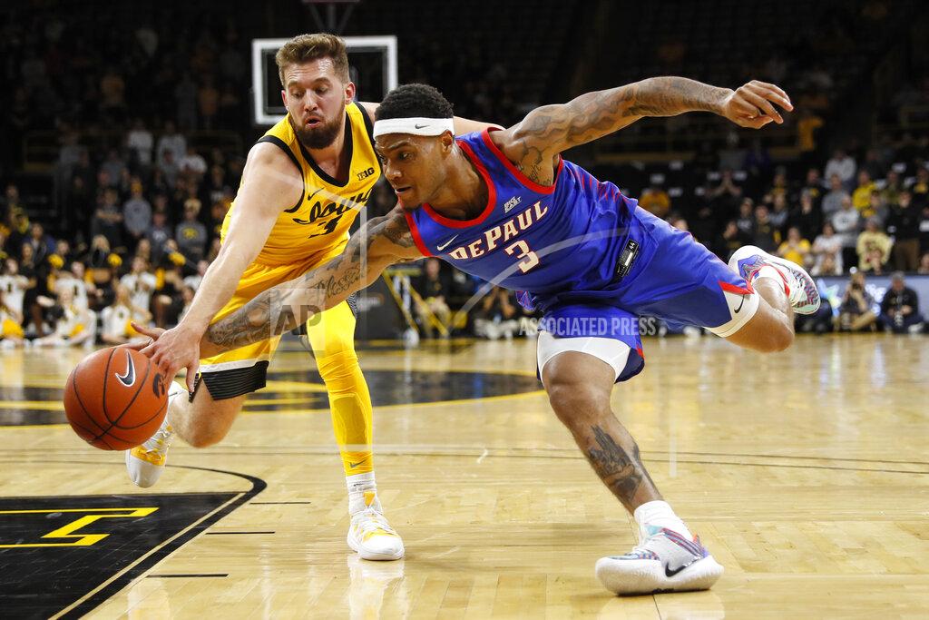 Charlie Neibergall Iowa guard Jordan Bohannon, left, fights for a loose ball with DePaul guard Devin Gage (3) during the first half of an NCAA college basketball game, Monday, Nov. 11, 2019, in Iowa City, Iowa.(AP Photo/Charlie Neibergall)