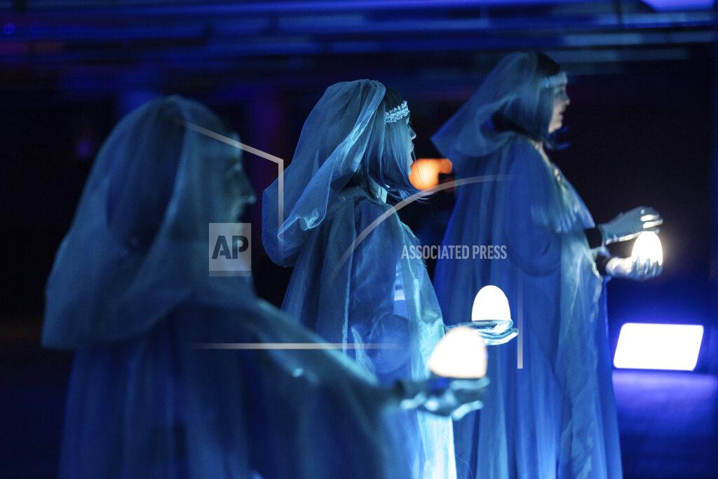 This image shows the three Rhinemaidens in a scene from Lyric Opera of Chicago's "Twilight: Gods," an adaptation of Wagner's "Götterdämmerung" staged in an underground parking garage in Chicago. (Kyle Flubacker/Lyric Opera of Chicago via AP)