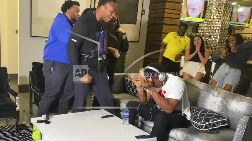Uncredited In this still image from video provided by the NFL, Julian Okwara, seated right, reacts to being selected by the Detroit Lions during the third round of the NFL football draft, Friday, April 24, 2020. (NFL via AP)