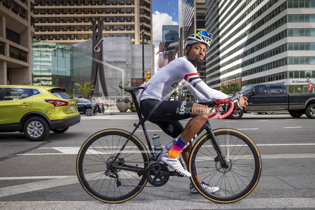 Alejandro A. Alvarez Siddeeq Shabazz rides his bicycle by Philadelphia City Hall on Friday, Sept. 3, 2021. Shabazz got into cycling because of the pandemic. Now he rides 200 miles a week, leads team rides and has been on the cover of a bicycling publication. (Alejandro A. Alvarez/The Philadelphia Inquirer via AP)