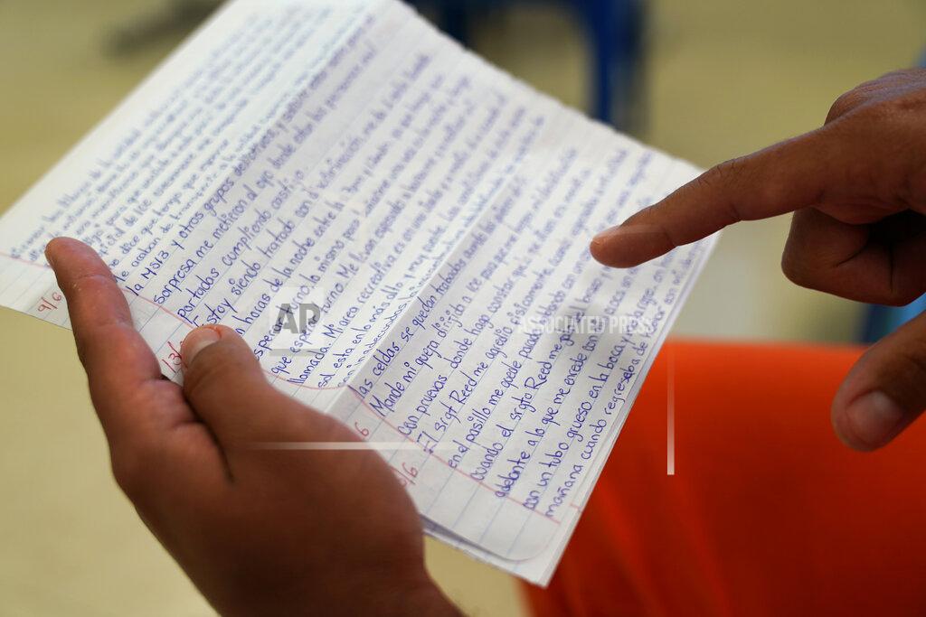 Gerald Herbert Immigration detainee Alexander Martinez points out his handwritten notations of allegations of abusive treatment, as he speaks during an interview with The Associated Press inside the Winn Correctional Center in Winnfield, La., Friday, July 30, 2021. (AP Photo/Gerald Herbert)