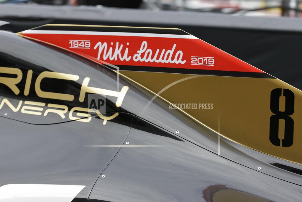 Luca Bruno The name of three-time Formula One world champion Niki Lauda is written on Romain Grosjean's Haas race car, top, during the second practice session at the Monaco racetrack, in Monaco, Thursday, May 23, 2019. Three-time Formula One world champion Niki Lauda, who won two of his titles after a horrific crash that left him with serious burns and went on to become a prominent figure in the aviation industry, has died on May 21, 2109. He was 70. (AP Photo/Luca Bruno)