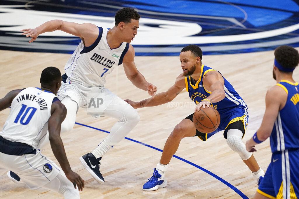 Tony Gutierrez Golden State Warriors guard Stephen Curry controls the ball next to Dallas Mavericks center Dwight Powell (7) during the second half of Game 4 of the NBA basketball playoffs Western Conference finals, Tuesday, May 24, 2022, in Dallas. (AP Photo/Tony Gutierrez)