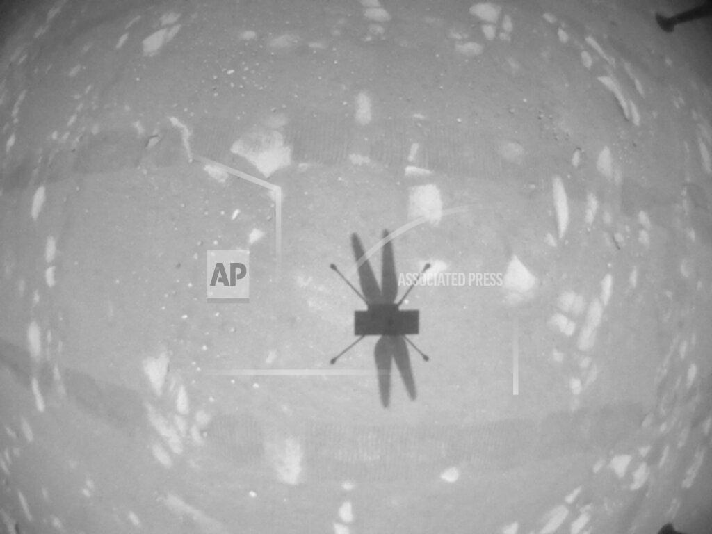 Uncredited FLE - In this April 22, 2021 file photo, made available by NASA, the Mars Ingenuity helicopter photographs its shadow with its black-and-white navigation camera during its second flight. Space engineer Loay Elbasyouni was part of the NASA team that made history this month by launching an experimental helicopter from the surface of Mars. But he says an expedition to his hometown in the Gaza Strip, where posters celebrate his achievement, feels even farther off because of Israeli and Egyptian restrictions. (NASA/JPL-Caltech via AP, File)