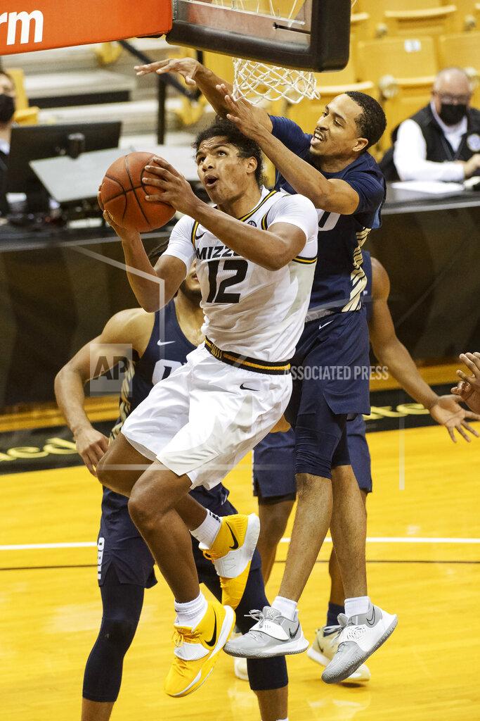 L.g. Patterson Missouri's Dru Smith shoots in front of Oral Roberts's Sheldon Stevens, right, during the second half of an NCAA college basketball game Wednesday, Nov. 25, 2020, in Columbia, Mo. (AP Photo/L.G. Patterson)