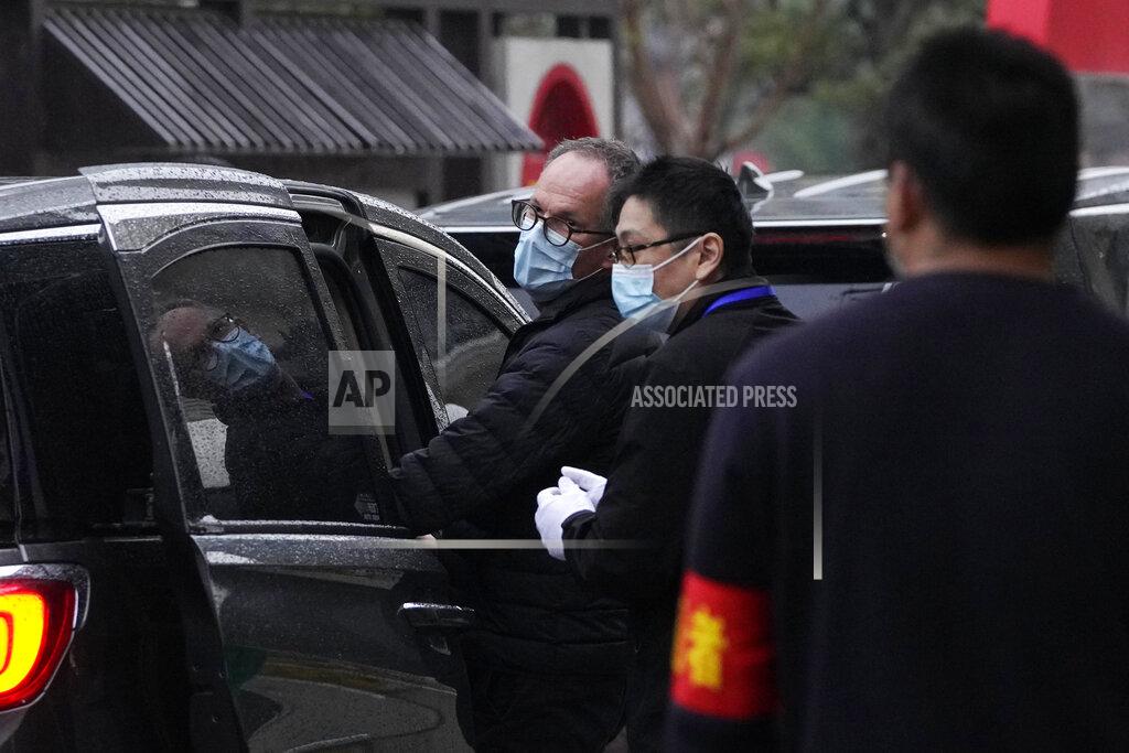 Ng Han Guan Peter Ben Embarek of the World Health Organization team, center left, leaves after a field visit at the Service Center for Party Members and Residents of Jiangxinyuan Community in Wuhan in central China's Hubei province on Thursday, Feb. 4, 2021. (AP Photo/Ng Han Guan)