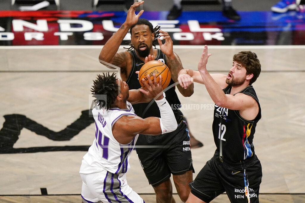 Kathy Willens Brooklyn Nets center DeAndre Jordan (6) and Nets forward Joe Harris (12) defend Sacramento Kings guard Buddy Hield (24) during the first quarter of an NBA basketball game, Tuesday, Feb. 23, 2021, in New York. (AP Photo/Kathy Willens)