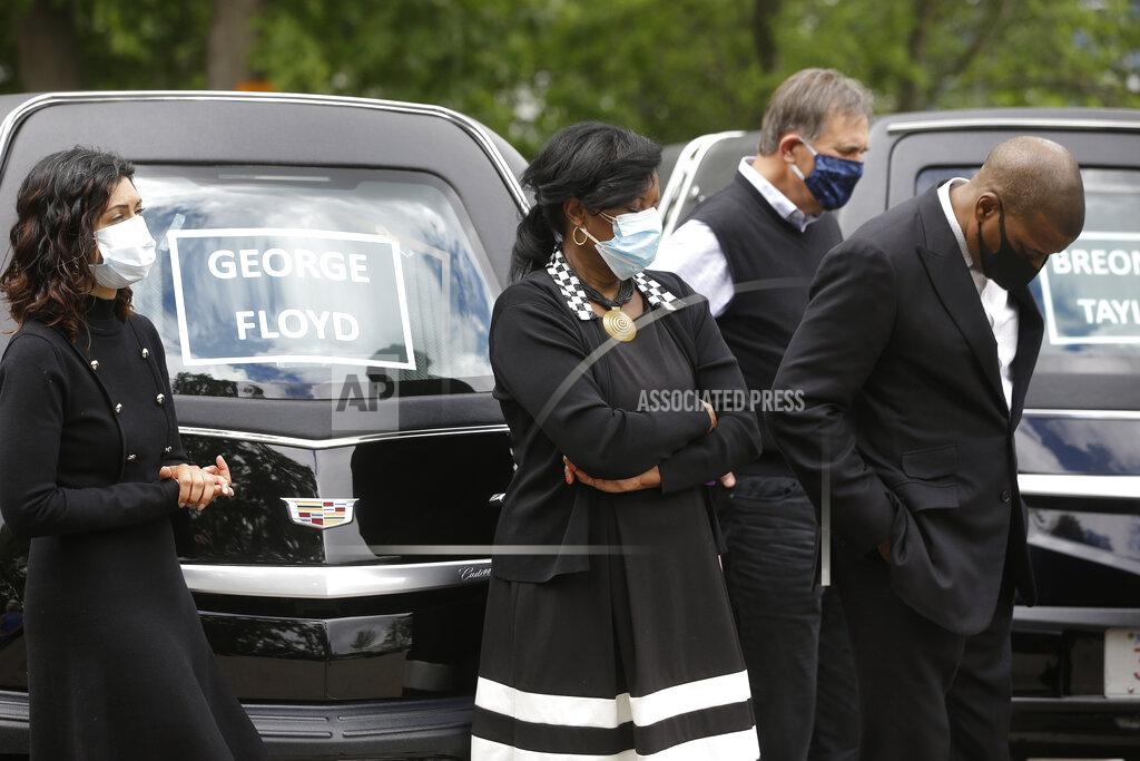 People pray Sunday, June 7, 2020 before taking part in a procession of vehicles, including three hearses meant to honor fallen George Floyd, Breonna Taylor, and Ahmaud Arbery, through Boston neighborhoods. The hearses were part of what organizers are calling #BostonBlackMemorial Funeral Procession. The procession and a number of protests were triggered by the death of George Floyd who died on May 25 as a Minneapolis police officer pressed his knee into his neck, ignoring his cries and bystander shouts until he eventually stopped moving. (AP Photo/Steven Senne)