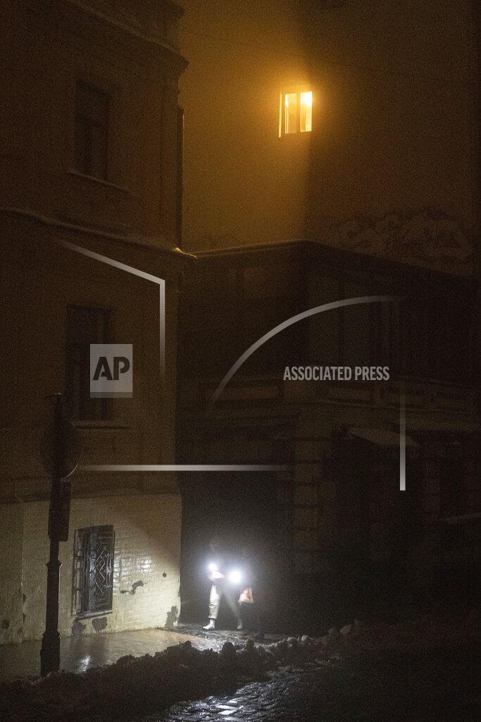 Evgeniy Maloletka People walk at the city center which lost electrical power after yesterday's Russian rocket attack in Kyiv, Ukraine, Thursday, Nov. 24, 2022. (AP Photo/Evgeniy Maloletka)