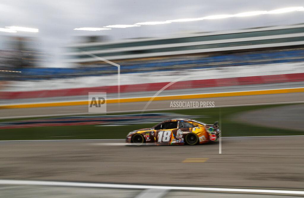 John Locher Kyle Busch (18) drives down pit lane during qualifying for the NASCAR Cup Series auto race at Las Vegas Motor Speedway, Friday, March 1, 2019, in Las Vegas. (AP Photo/John Locher)
