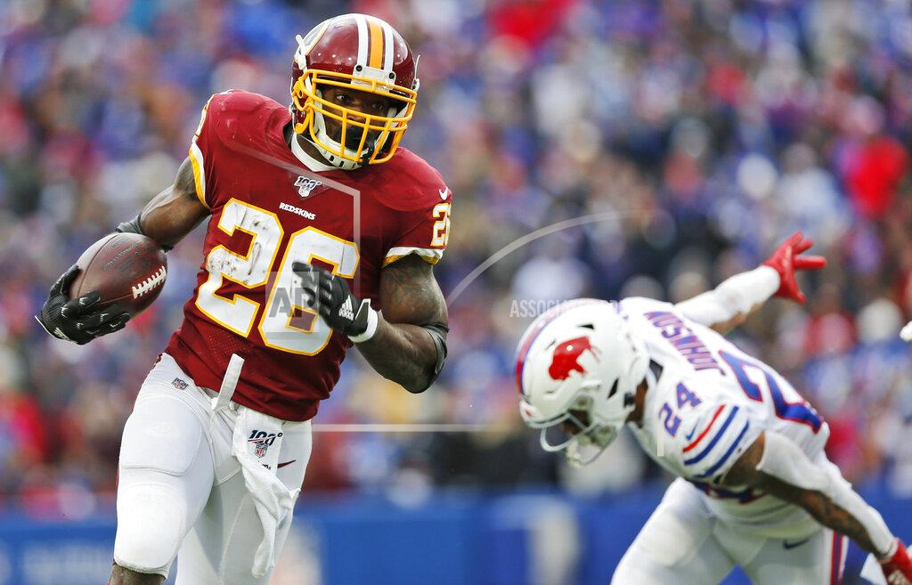 John Munson Washington Redskins running back Adrian Peterson (26) rushes against Buffalo Bills cornerback Taron Johnson (24) during the first half of an NFL football game, Sunday, Nov. 3, 2019, in Orchard Park, N.Y. (AP Photo/John Munson)