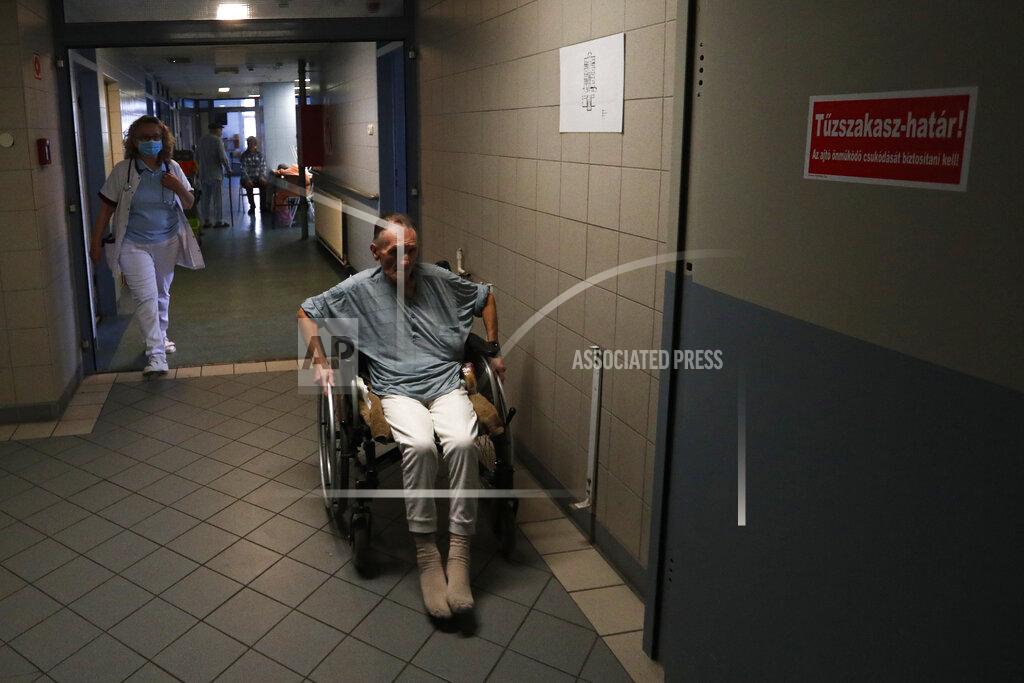 Laszlo Balogh An elderly homeless man uses a wheelchair at the hospital for the homeless in Budapest, Hungary, Wednesday, April 14, 2021. A bitter conflict has emerged between Hungary’s right-wing government and the liberal leadership of the country's capital city over a hospital for the homeless that may soon have to close. The Budapest hospital provides medical and social services and shelter to more than 1,000 people annually. But the Hungarian government has ordered it to vacate the state-owned building it occupies. Budapest's mayor says the eviction will risk the lives of the hospital's homeless patients as Hungary struggles with a deadly COVID-19 surge. (AP Photo/Laszlo Balogh)