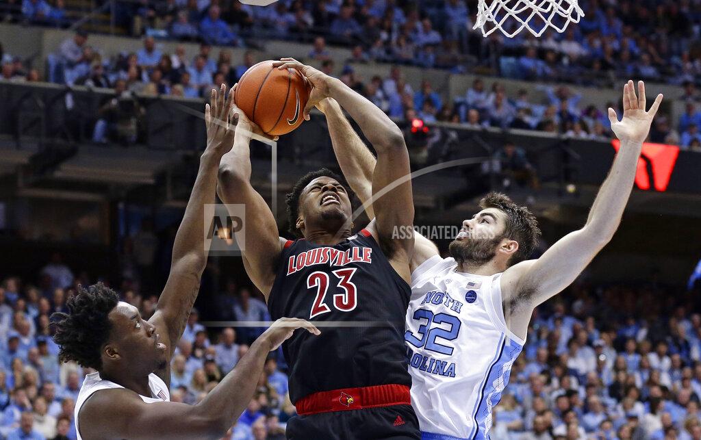 Gerry Broome Louisville's Steven Enoch (23) drives to the basket while North Carolina's Luke Maye (32) and Nassir Little defend during the second half of an NCAA college basketball game in Chapel Hill, N.C., Saturday, Jan. 12, 2019. Louisville won 83-62. (AP Photo/Gerry Broome)