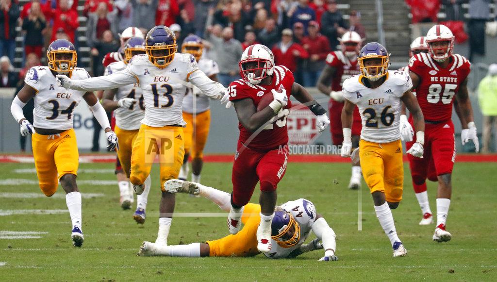 Chris Seward North Carolina State's Reggie Gallaspy II (25) breaks away from East Carolina's Myles Berry (34), Davondre Robinson (13), Kendall Futrell (44) and Colby Gore (26) for a long gain during the second half of NCAA college football game in Raleigh, N.C., Saturday, Dec. 1, 2018. (AP Photo/Chris Seward)