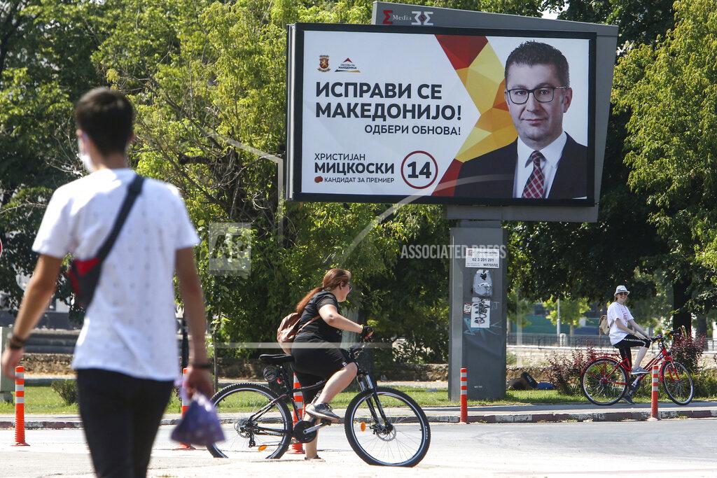 Boris Grdanoski An election campaign poster of the leader of the largest opposition party VMRO-DPMNE Hristijan Mickoski, is displayed in a street in Skopje, North Macedonia on Saturday, July 11, 2020. North Macedonia holds its first parliamentary election under its new country name this week, with voters heading to the polls during an alarming spike of coronavirus cases in the small Balkan nation. (AP Photo/Boris Grdanoski)