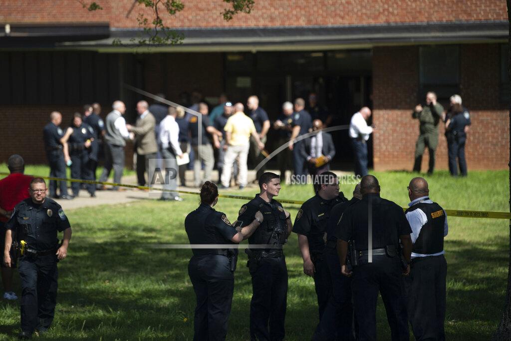Saul Young Law enforcement officers respond to a shooting at Austin-East Magnet High School in Knoxville, Tenn., Monday, April 12, 2021. Authorities say multiple people including a police officer have been shot at the school. (Saul Young/Knoxville News Sentinel via AP)