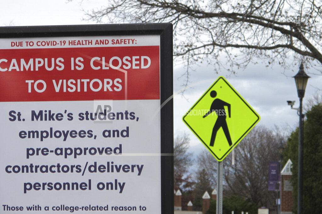 Lisa Rathke FILE - In this Nov. 12, 2020, file photo, a sign at the entranceway to St. Michael's College in Colchester, Vt., says that the campus is closed to visitors due to a COVID-19 outbreak. Colleges throughout the U.S. are assuring students that this coming fall will bring a return to in-person classes, intramural sports and mostly full dormitories. But those promises come with asterisks. (AP Photo/Lisa Rathke)