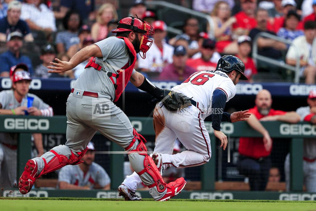 Butch Dill St. Louis Cardinals catcher Austin Romine, left, tags out Atlanta Braves' Travis d'Arnaud (16) as d'Arnaud tries to get back to third base during the second inning of a baseball game Monday, July 4, 2022, in Atlanta. (AP Photo/Butch Dill)