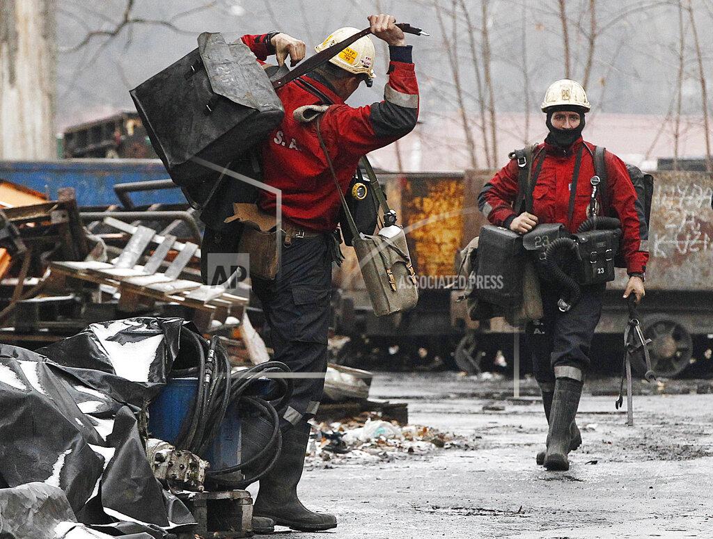 Czarek Sokolowski FILE - In this Nov. 21, 2018, file photo, a mining rescue team arrives for a regular shift at the Wujek coal mine in Katowice, in southern Poland. The coronavirus has ripped through Poland's coal mines, where men descend deep underground in tightly packed elevators and work shoulder-to-shoulder. The virus hot spots, centered in the southern Silesia region, have paralyzed an already-troubled industry, forcing many to stay home from work and triggering a three-week closure of many state-run mines. (AP Photo/Czarek Sokolowski, File)