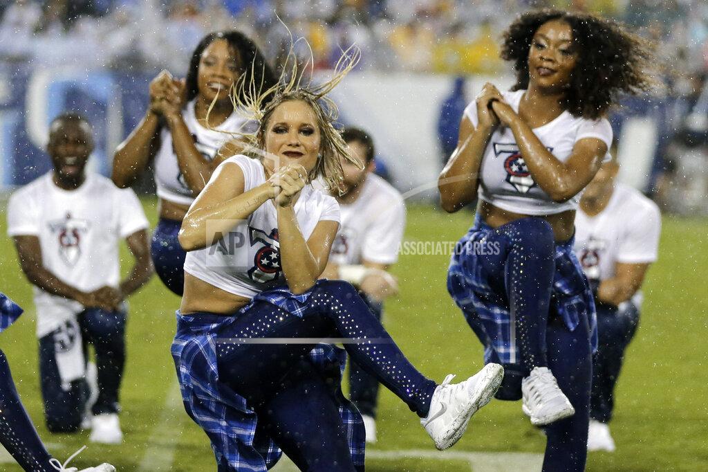 James Kenney Tennessee Titans cheerleaders perform in the rain during the first half of a preseason NFL football game between the Titans and the Pittsburgh Steelers Sunday, Aug. 25, 2019, in Nashville, Tenn. (AP Photo/James Kenney)