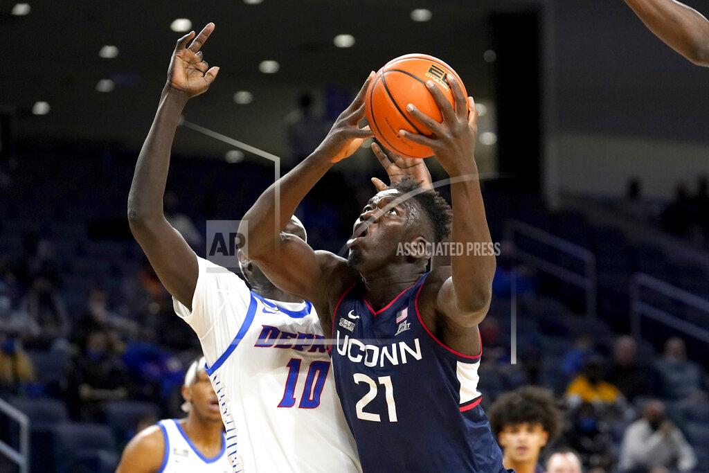 Charles Rex Arbogast Connecticut's Adama Sanogo (21) looks to the basket as DePaul's Yor Anei defends during the first half of an NCAA college basketball game Saturday, Jan. 29, 2022, in Chicago. (AP Photo/Charles Rex Arbogast)